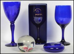 A group of Bristol Blue glass to include wine glasses goblets paperweights etc. Tallest measures