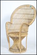 A vintage 20th century cane wicker rattan weave conservatory chair, having a peacock fan back with