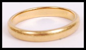 An 22ct hallmarked gold ring of usual simple form bearing Birmingham assay marks. Weighs 3.8g and