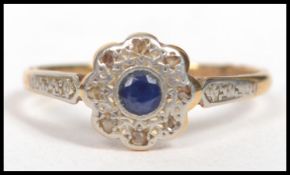 A vintage ladies 18ct gold and platinum diamond and sapphire ring, having a central sapphire with