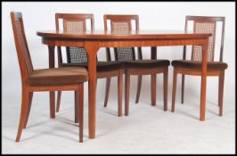 A retro 20th century teak D-end extending dining table by Mcintosch together with four G plan high