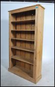 A good quality reclaimed pine antique style tall open window bookcase cabinet. Raised on a plinth