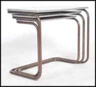 A trio nest of counter lever tables of tubular met