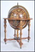 An antique style cocktail drinks globe having with applied terrestrial design with flip top lid