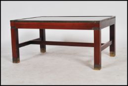 A 20th century mahogany and brass style campaign table of rectangular form with inset chess top.