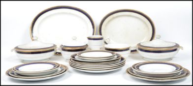 A Mintons tea service, gilded band of foliage above cobalt blue banding, pattern no. 14095,