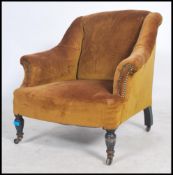 A Victorian mahogany armchair, upholstered with button fabric, on turned legs with ceramic castors