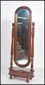 An antique French style mahogany bow front cheval dressing mirror with drawer to the plinth base