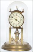 A vintage 20th century glass domed brass anniversary clock raised on a stepped circular base with