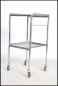 An original mid century Industrial surgeons theatre trolley of tubular metal and stainless steel