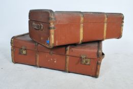 A pair of vintage 20th century canvas and wooden bound steamer trunks with locks and claps to