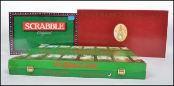 A Centenary Peter Rabbit race game in original red box along with a sealed 1980s Scrabble game and a