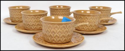 A vintage 20th century set of six stoneware tea cups and saucers by Tams decorated in a geometric