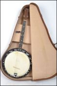 A vintage 20th century four string banjo guitar by Dallas complete in vintage case.