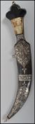 A Middle Eastern curved Jambiya dagger having a decorative silver inlaid blade with ebony and bone