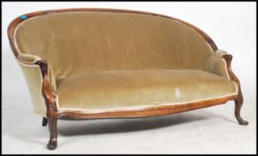 A good 19th century Victorian sofa settee being raised on mahogany cabriole legs with show wood