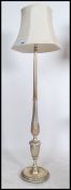 A contemporary silvered standard lamp of reeded form with the terraced base and good shade ( see