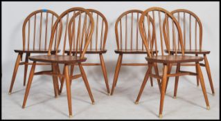 A set of six Ercol spindle back dining chairs on tapered legs in the blonde colourway. Measures