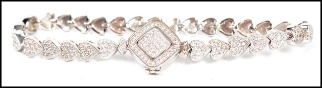 A ladies contemporary silver and cz adorned heart shaped line bracelet with link formations and