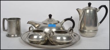 A retro Tudoric style pewter made tea service by Hall Brothers, including the tray, teapot etc.