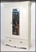 An Edwardian walnut shabby chic painted single wardrobe armoire. The base with shaped legs having