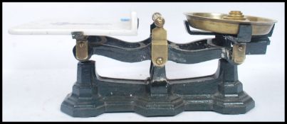 A set of late Victorian Parnell & Son Bristol cast metal and ceramic weighing scales raised on three