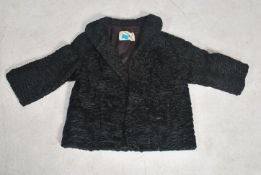 A vintage mid century Persian lamb 3/4 length fur coat by The Weald Furriers with makers label to