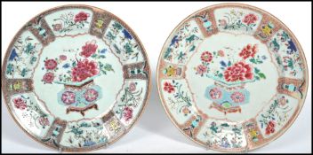 A pair of 18th century import Chinoiserie cabinet plates each with a central decorated panel.