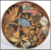 A stunning 18th century Japanese Imari cabinet plate depicting a gilt fighting cock amongst fauna