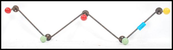 A vintage mid century retro sputnik atomic coat rack of ebonised zig zag form with coloured ball