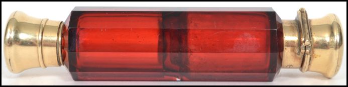 A 19th century Victorian cranberry glass double ended perfume phial / vinaigrette having gilt