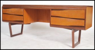 A retro teak wood White and Newton desk, raised on
