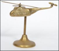 A 20th century ' trench art ' apprentice piece of a helicopter with four blades raised on a circular