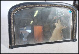 A large ebonised 19th century Victorian ebonised overmantel mirror having gilt acanthus leaf and
