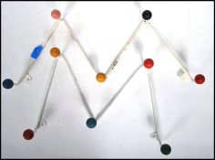 A pair of retro 1950's atomic / sputnik style wall mounted coat racks with colourful finial ends