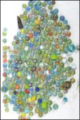 A large collection of vintage 20th century and other glass marbles to include many helix, cat eye