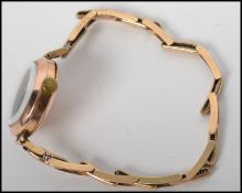 A vintage 20th century ladies  9ct gold Swiss movement wrist watch, enamel face on a 9ct bracelet.