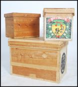 A stack of three retro 20th century graduating Japanese tea chests with remnants of advertising to