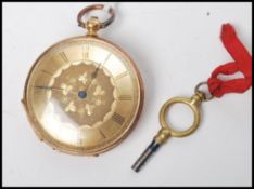 An 18ct gold early 20th century open faced fob / pocket watch with engine turned dial having faceted