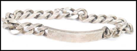 A silver ( stamped 925 ) identity bracelet, the central identity plate flanked by silver curb link