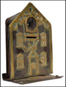 An 19th century worked metal and brass money box in the form of a bank building, retaining