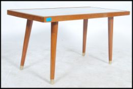 A teak top carved coffee table depicting Oriental scenes having and inset glass top raised on