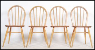 A set of four 20th century Ercol ' Windsor ' light elm and beech stick and hoop back dining