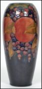 An early 20th century William Moorcroft hand painted ceramic tubelined vase decorated in the