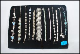A collection of vintage ladies bracelets to include tennis, rhinestone, mother of pearl, heart etc.
