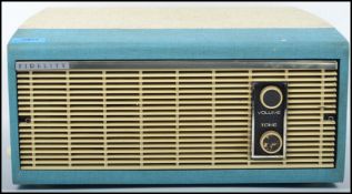 A vintage retro 20th century record player by Fidelity set in a two tone case with dials to front.