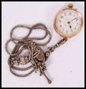 A vintage early 20th century 14ct gold ladies fob watch being within open face with gilt enamel