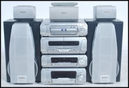 A 1990's / late 20th century Technics stacking hi-fi systems to include an amp. tape, dvd and