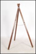 A 19th century mahogany and brass embellished 3 fold slatted artists travelling easel. With twin