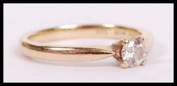 A 9ct gold and diamond ring having single solitair